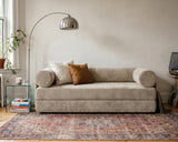 S8 Sleeper Sofa Bed in a living room, styled with two cushions, a rug, and a floor lamp beside it.