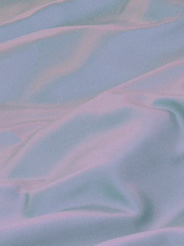 A close-up of a pastel-colored fabric with smooth, flowing folds, showcasing the soft texture and gentle sheen