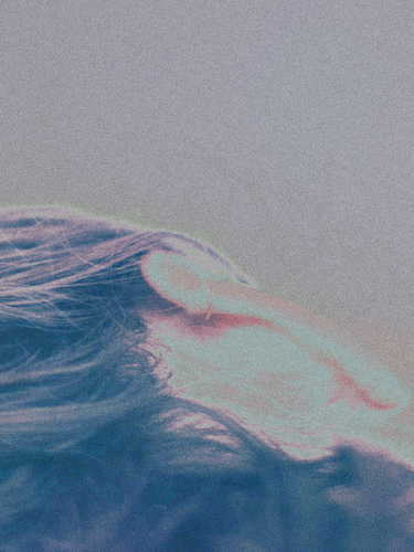 An abstract close-up image of a person’s head resting, with soft lighting and gentle hues, symbolizing relaxation and peacefulness