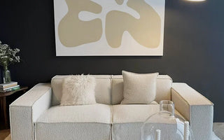 modular loveseat sofa in a living room with an art on the wall