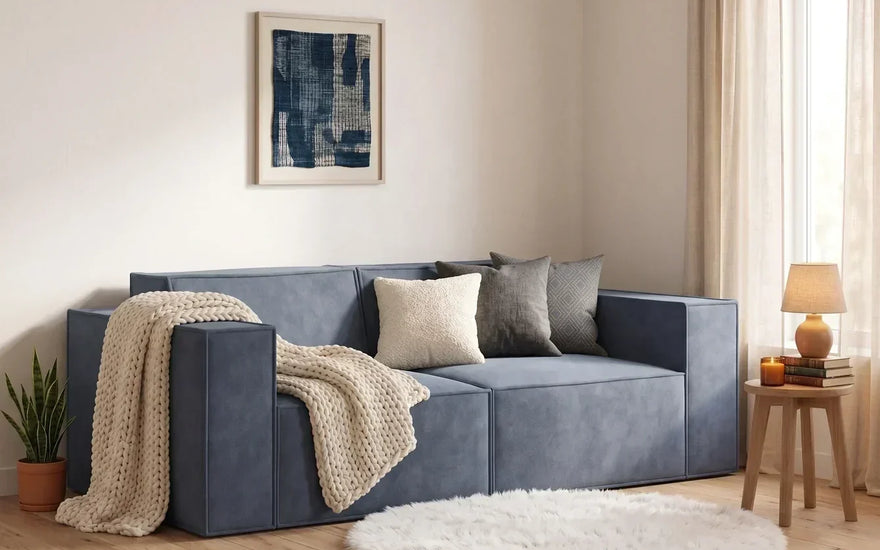 modular sofa on a small living room with round rug and a blanket on the loveseat