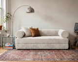 S8 Sleeper Sofa Bed in a living room, styled with two cushions, a rug, and a floor lamp beside it.